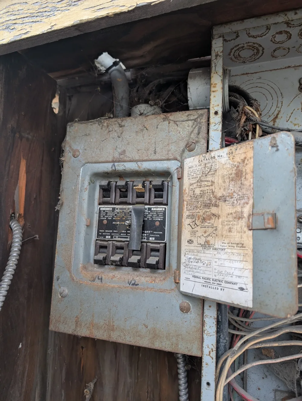 Older Federal Pacific electrical panel with the cover open